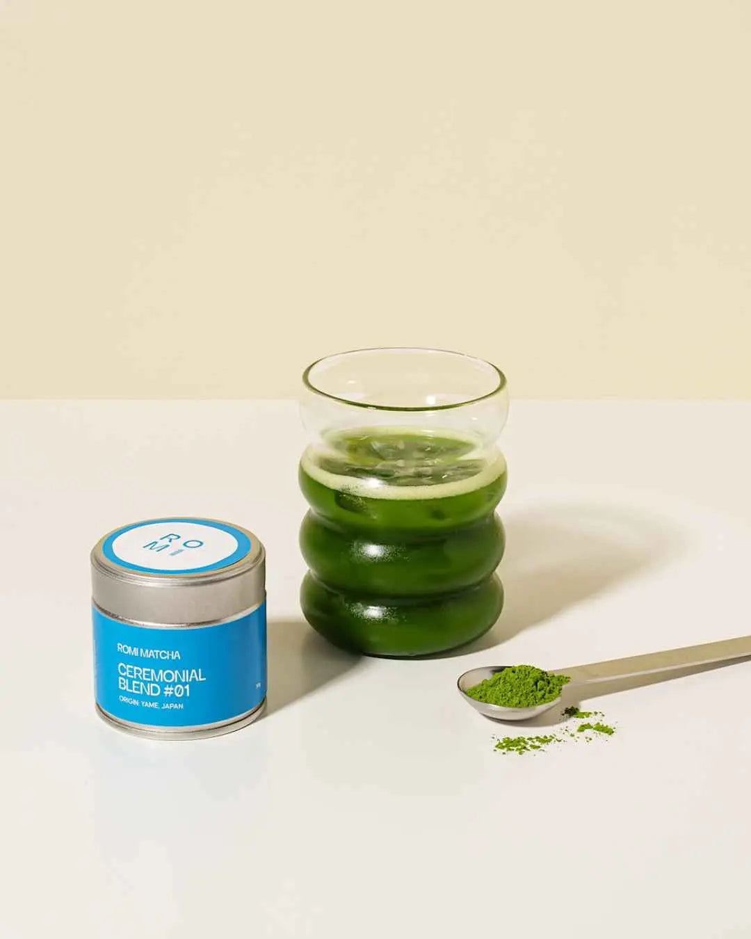 Romi Matcha Ceremonial Blend #01 30g tin with clear matcha in a glass and tea powder in a spoon