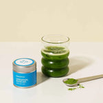 Romi Matcha Ceremonial Blend #01 30g tin with clear matcha in a glass and tea powder in a spoon