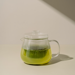 Clear glass teapot with Kabusecha Premium Shaded Green Tea on neutral background | Romi Matcha