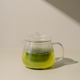 Clear glass teapot with Kabusecha Premium Shaded Green Tea on neutral background | Romi Matcha