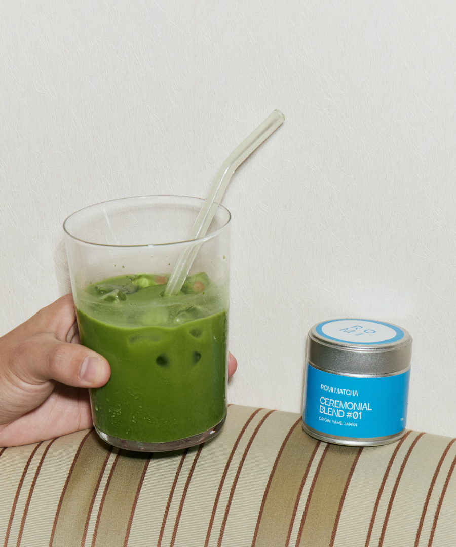Romi Matcha Ceremonial Blend #01 matcha latte in glass with straw on striped surface
