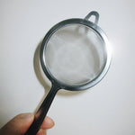 hand holding tea sifter | Romi Matcha