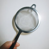 hand holding tea sifter | Romi Matcha