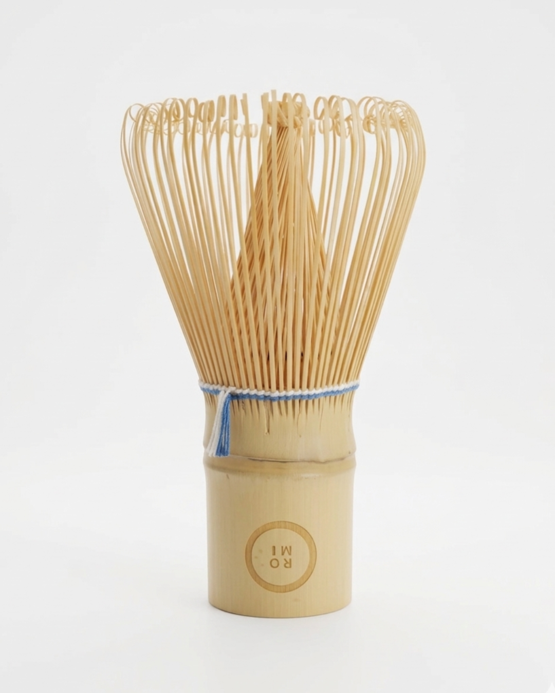 Bamboo whisk with a wooden handle on a white background