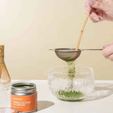 Romi Matcha Okumidori with sieve and bamboo spoon in a bowl | Romi Matcha