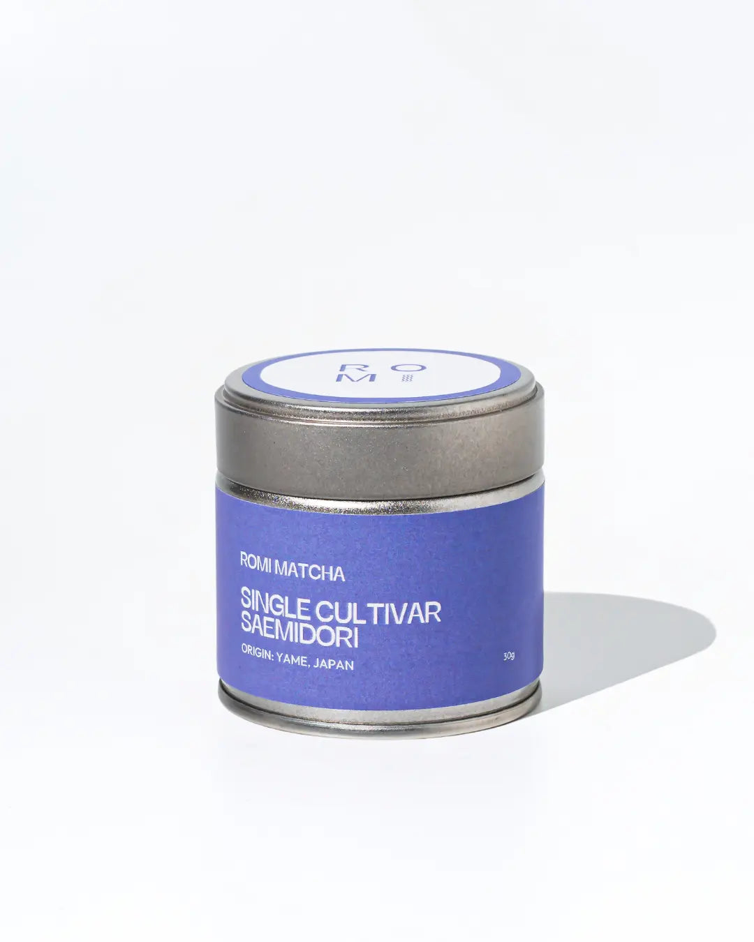 Tea canister with purple Romi Matcha label on a white background